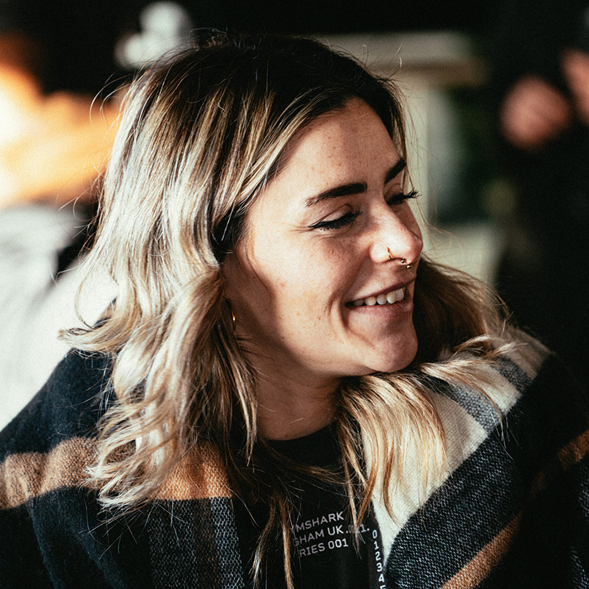 Smiling woman with nose ring and scarf