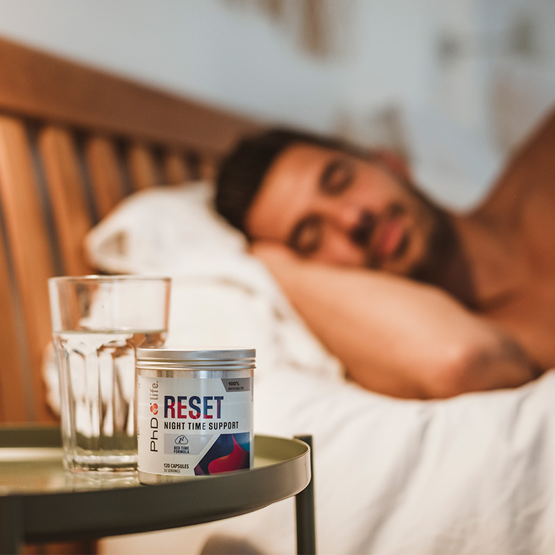 Man sleeping with reset on bedside table