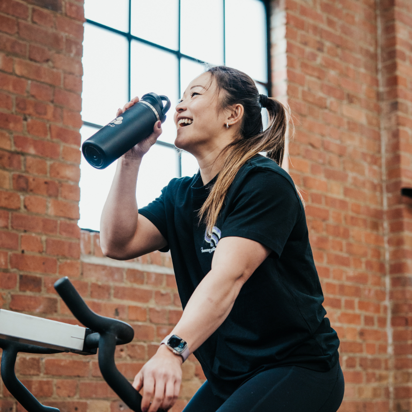 Girl exercising and drinking